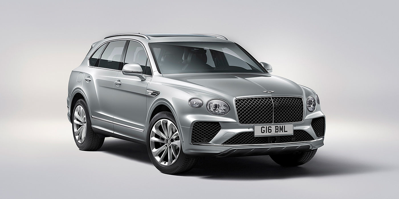 Bentley Knokke Bentley Bentayga in Moonbeam paint, front three-quarter view, featuring a matrix grille and elliptical LED headlights.