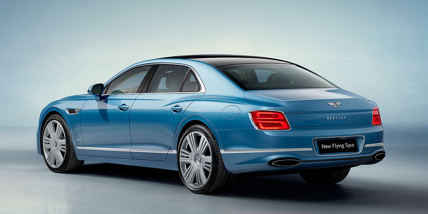 Bentley Knokke New Bentley Flying Spur Azure sedan rear view in Light windsor blue by Mulliner paint with 22 inch Azure wheels and chrome exterior details