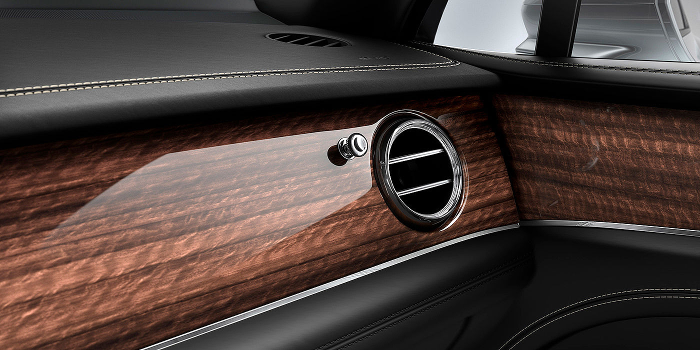 Bentley Knokke Bentley Bentayga front interior Crown Cut Walnut veneer and chrome air vent.