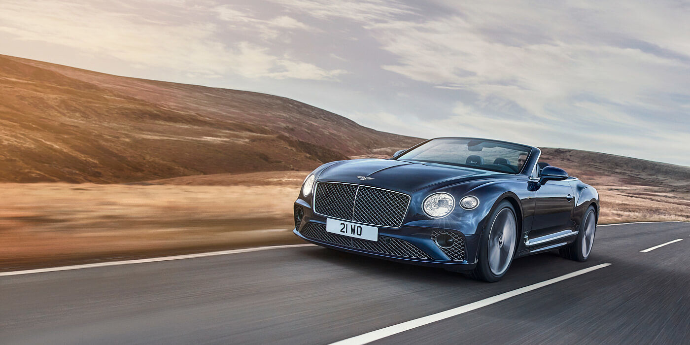 Bentley Knokke Bentley Continental GTC Speed convertible in Peacock paint side front 34 dynamic