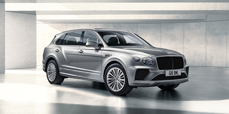 Bentley Knokke Bentley Bentayga Extended Wheelbase SUV front three quarter in Moonbeam paint with a grey background